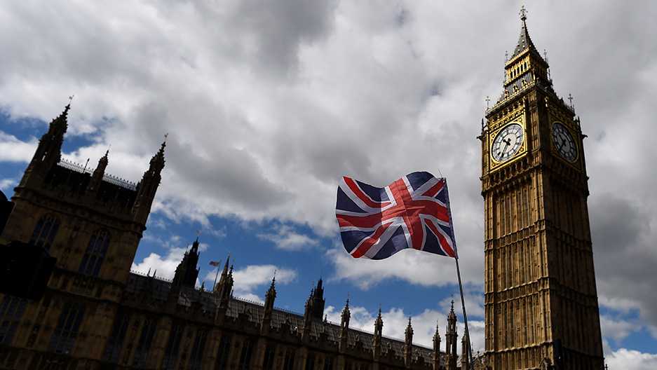 <p>The national flag of the United Kingdom flies near the Houses of Parliament the day before a general election in central London, Britain. </p>

