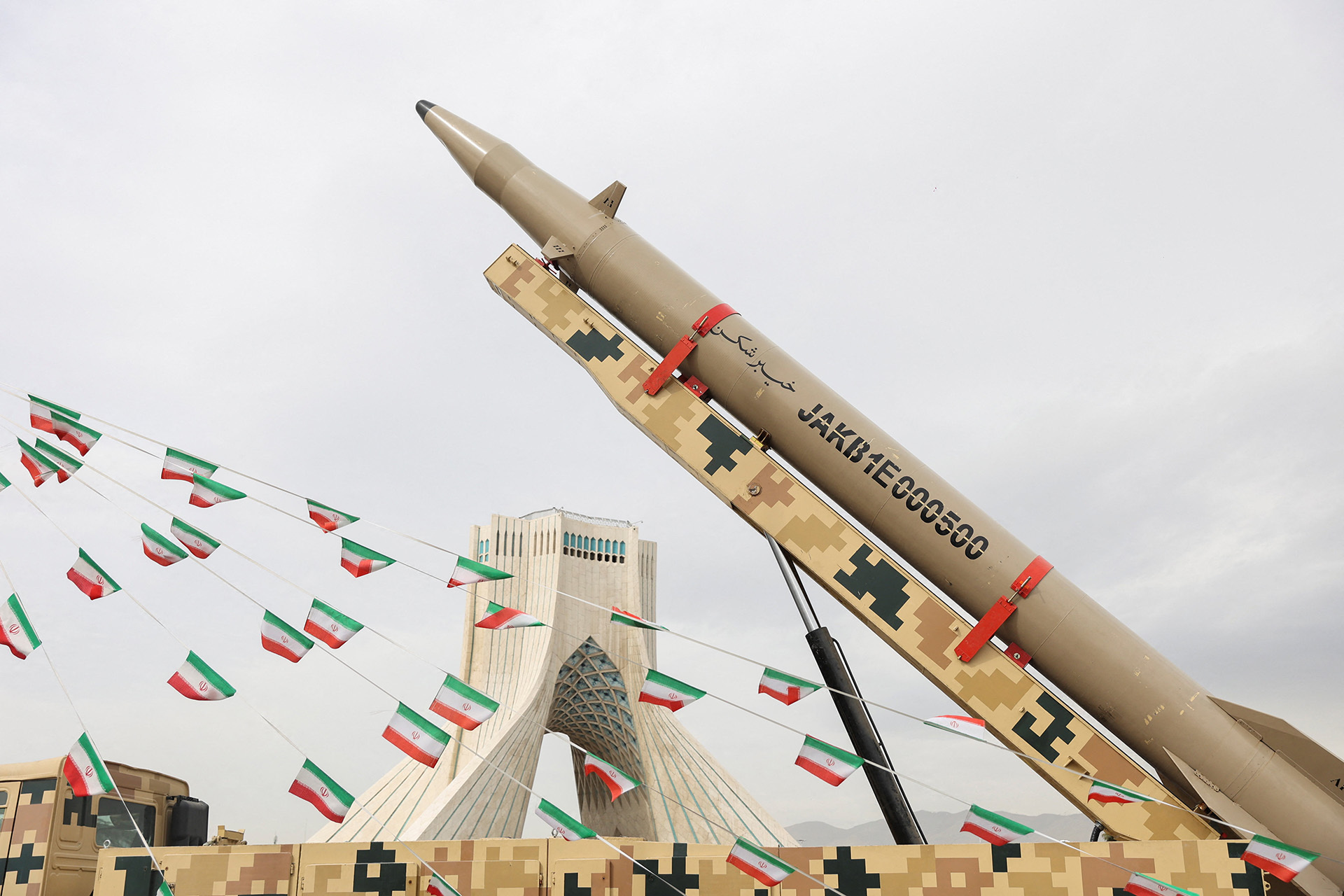 <p>Iranian flags hang next to a missile on display during the forty-seventh anniversary of the Islamic Revolution in Tehran, Iran, February 11, 2026.</p>
