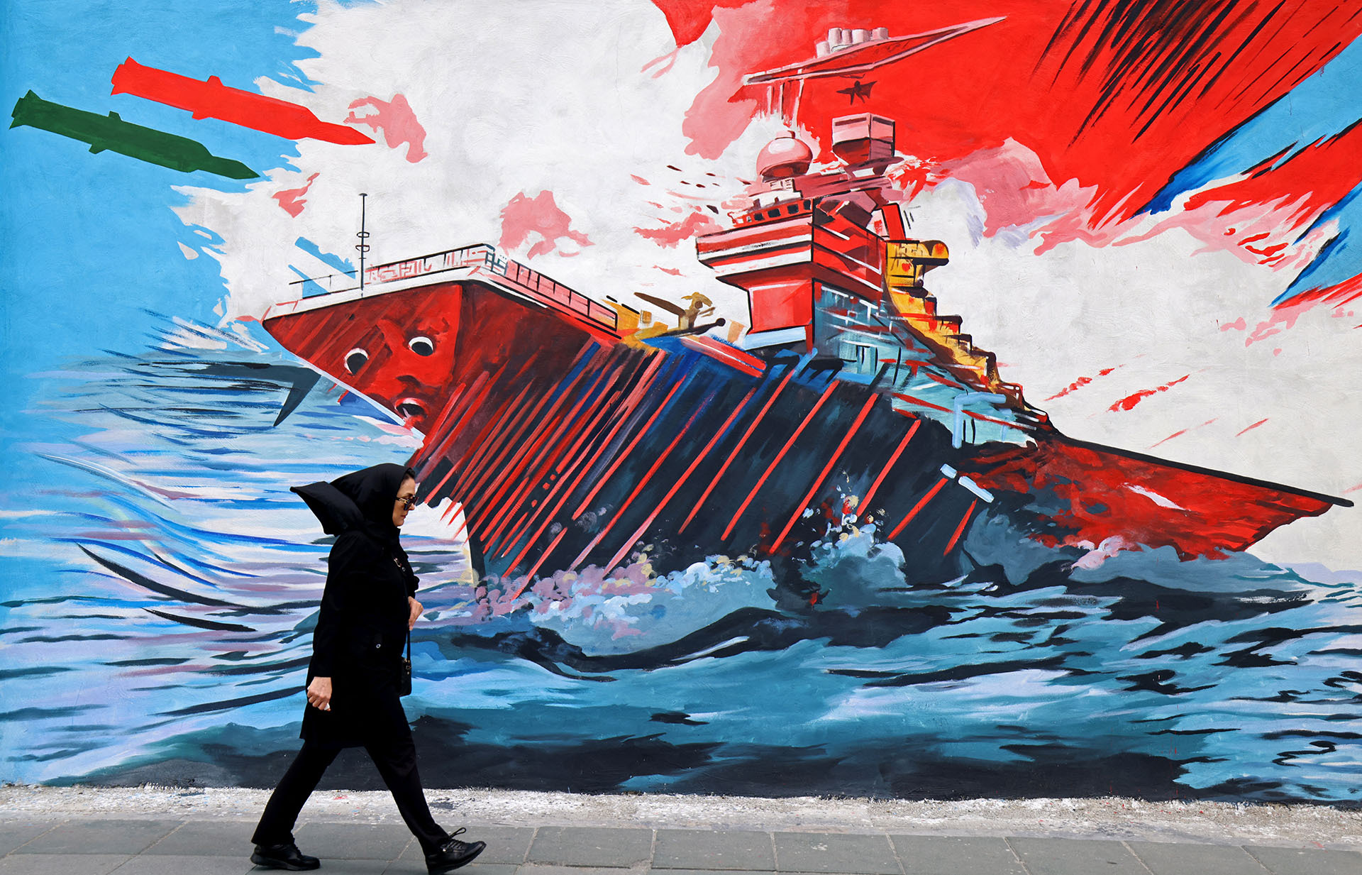 <p>A woman walks past an anti-United States and anti-Israel mural in Tehran on April 8, 2026.</p>
