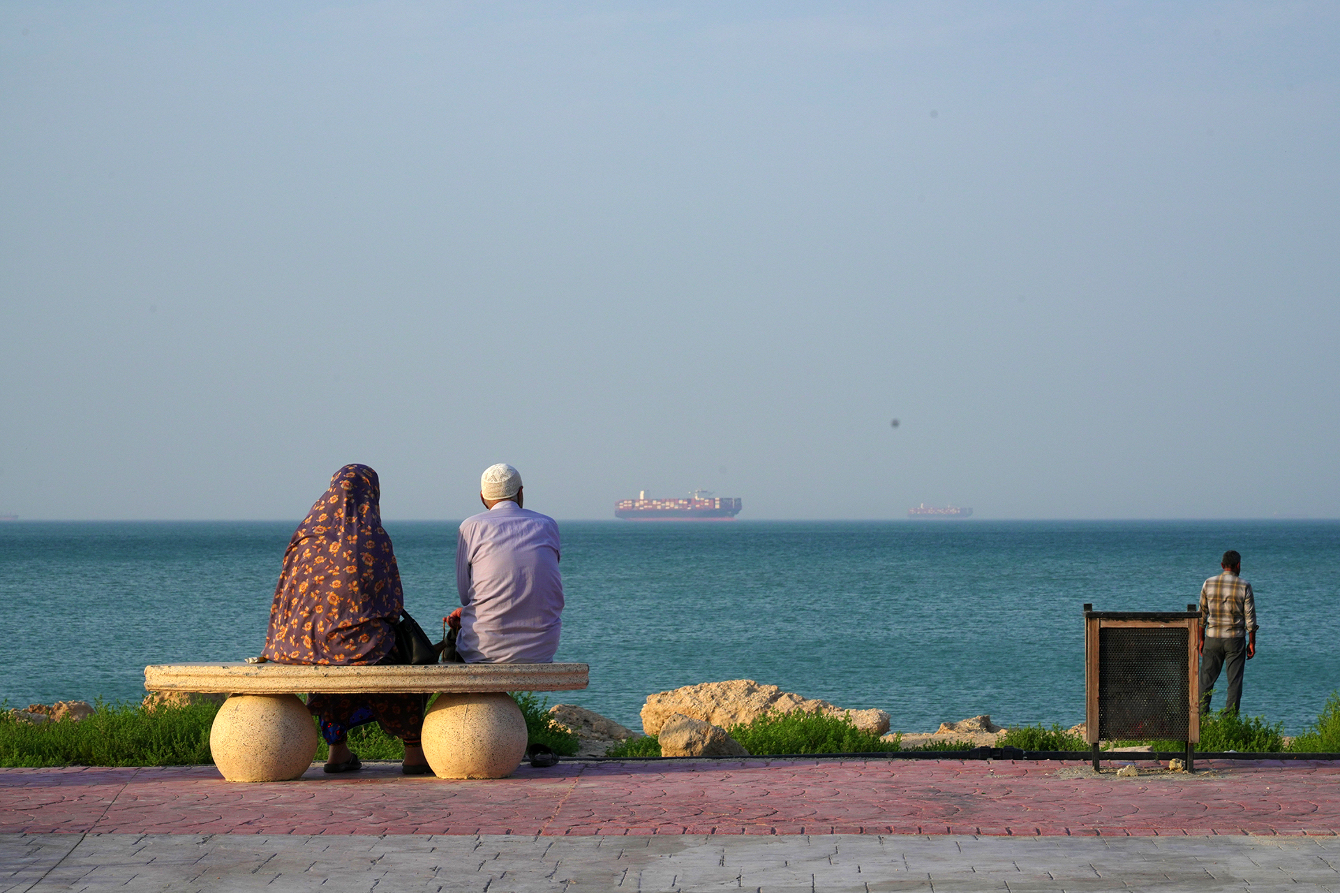 <p>People sit at the shoreline as boats navigate the sea on April 28, 2026, on Qeshm Island, Iran, in the Strait of Hormuz. </p>
