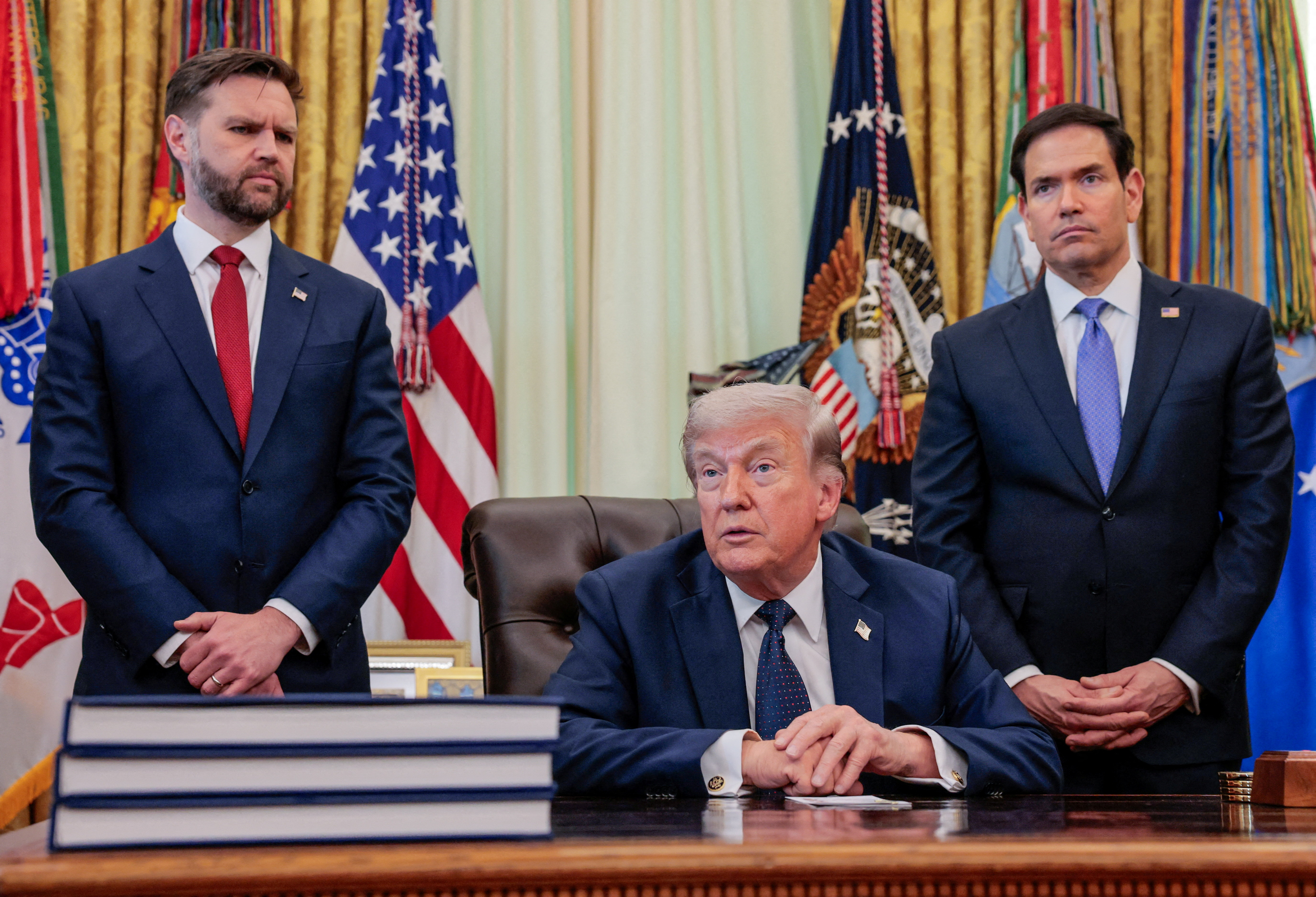 U.S. President Donald Trump speaks in the Oval Office, with Vice President JD Vance and Secretary of State Marco Rubio standing behind him, at the White House in Washington, D.C., U.S., on April 23, 2026.