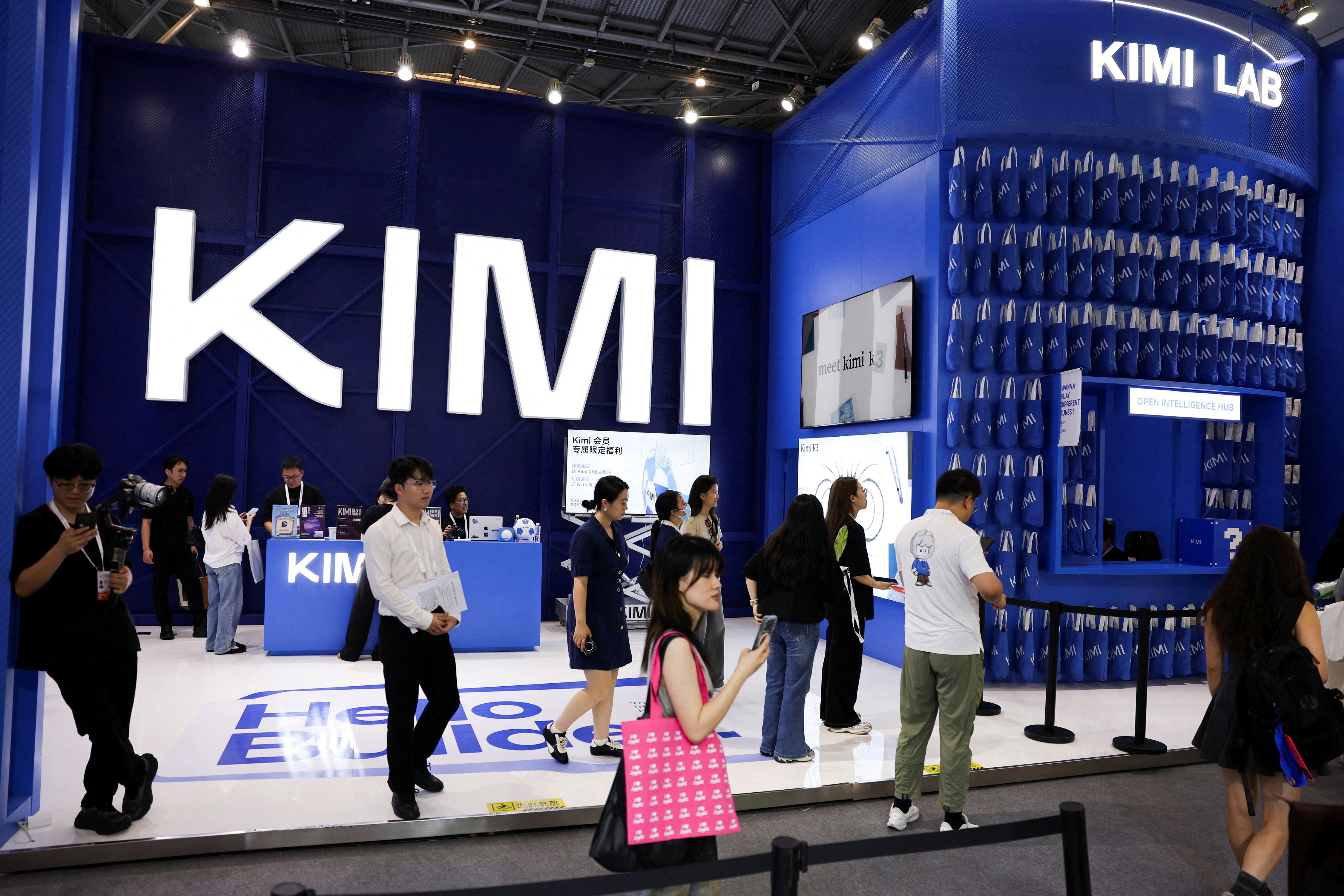 <p>People walk past the Moonshot booth promoting its Kimi K3 AI model, during the World Artificial Intelligence Conference in Shanghai, China, July 17, 2026. </p>