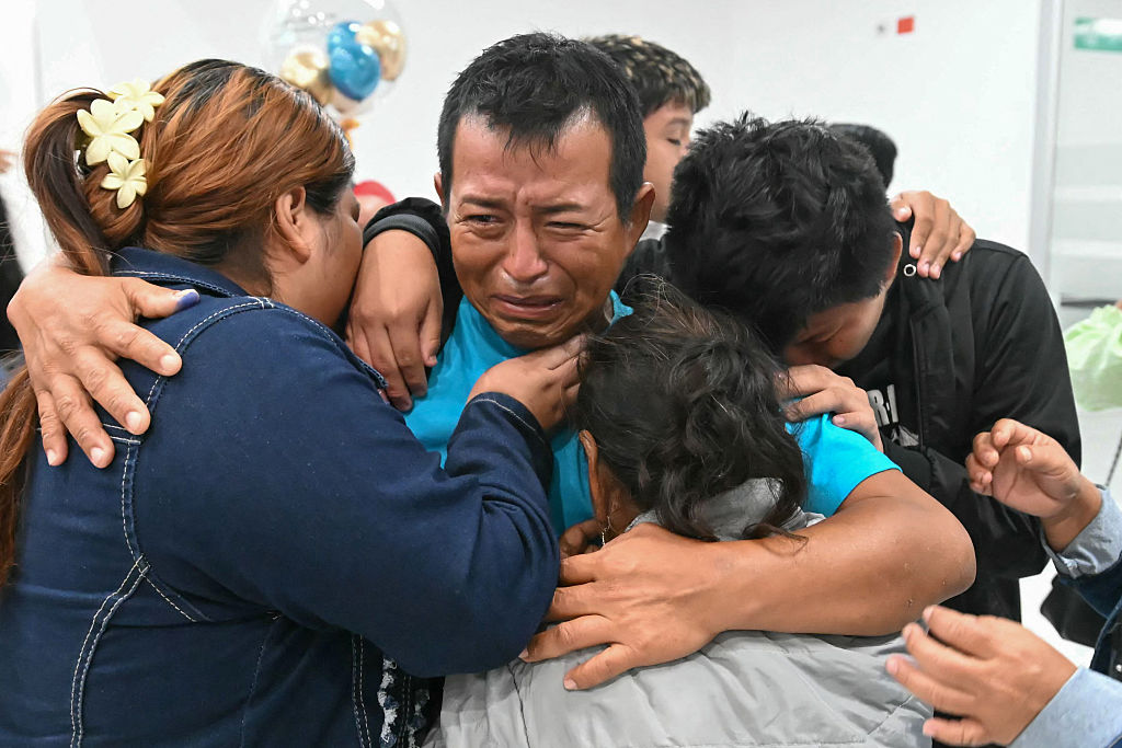 Oscar Marin (C), rescued from the Ecuadorian fishing vessel "Don Maca" after it went missing, greets relatives upon his arrival at the Eloy Alfaro Manta ainternational airport, in Manta, Ecuador, from El Salvador, on April 7, 2026.